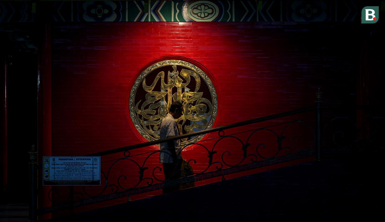 Seorang jemaah memasuki Masjid Cheng Ho, Genteng, Surabaya untuk melaksanakan ibadah salat magrib pada Selasa (14/11/2023). (Bola.com/Bagaskara Lazuardi)