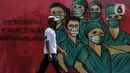 Pejalan kaki melintas di depan mural tentang pandemi virus COVID-19 di Jalan Raya Jakarta-Bogor, Depok, Jawa Barat, Selasa (7/4/2020). Mural tersebut sebagai bentuk dukungan kepada tenaga medis yang menjadi garda terdepan menghadapi COVID-19 di Indonesia. (Liputan6.com/Helmi Fithriansyah)