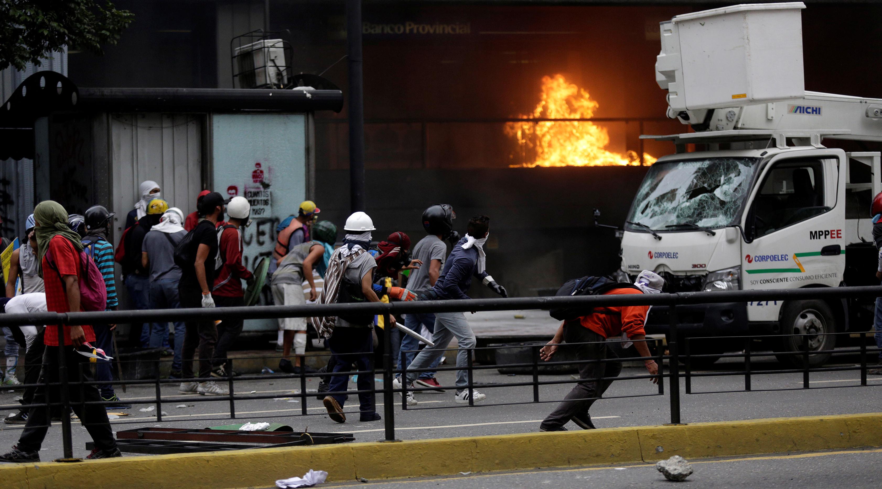 Sejumlah demonstran saat menyerang Gedung Pengadilan Tinggi Venezuela selama kerusuhan menuntut Presiden Nicolas Maduro di Caracas (7/6). (Reuters/Marco Bello)