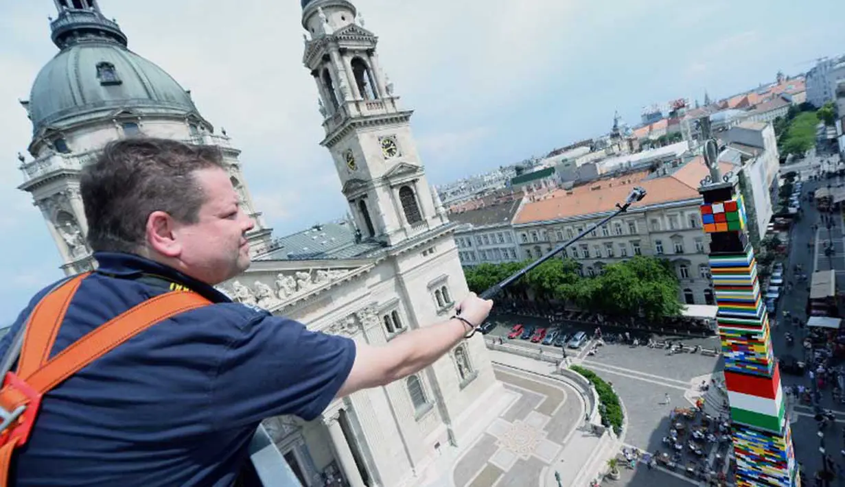 Pihak Guinness Book of Record sedang melakukan pengukuran terhadap menara Lego di Hungaria, Minggu (25/05/2014) (AFP PHOTO/ATTILA KISBENEDEK).