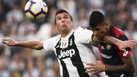 Striker Juventus, Mario Mandzukic, berebut bola dengan bek Genoa, Cristian Romero, pada laga Serie A Italia di Stadion Allianz, Turin, Sabtu (20/10). Kedua klub bermain imbang 1-1. (AFP/Marco Bertorello)