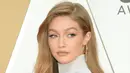 Gigi Hadid berpose di karpet merah saat menghadiri CMA Awards tahunan ke-53 di Bridgestone Arena di Nashville, Tennessee (13/11/2019). Gigi tampil cantik memamerkan lengannya yang langsing, dan bahan reflektif yang agak tipis memamerkan sedikit branya. (Jason Kempin/Getty Images/AFP)