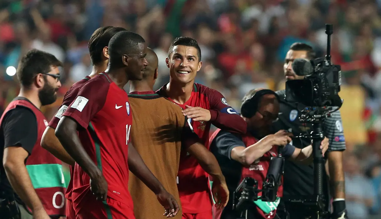 Pemain timnas Portugal, Cristiano Ronaldo dan timnya merayakan kemenangan atas Swiss pada laga pamungkas kualifikasi Piala Dunia 2018 zona Eropa di Stadion da Luz, Selasa (10/10). Portugal lolos ke Piala Dunia 2018 usai menang 2-0. (AP/Armando Franca)
