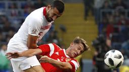 Aksi pemain Turki, Okay Yokuslu (kiri) menghalau bola dari pemain Rusia, Aleksey Miranchuk pada laga uji coba di VEB Arena stadium, Moskow, Rusia, (5/6/2018). Rusia bermain imbang 1-1. (AP/Pavel Golovkin)