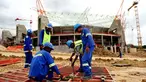 South African labourers work in front of Nelspruit's new football stadium on January 19, 2009 that will be used as one of the 10 stadiums across South Africa for the 2010 World Cup. AFP PHOTO/ALEXANDER JOE 