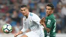 Penyerang Real Madrid, Cristiano Ronaldo berebut bola dengan pemain Real Betis dalam laga pekan lima La Liga di Santiago Bernabeu, Rabu (20/9). Real Madrid keok 0-1 dari tamunya, Real Betis. (GABRIEL BOUYS/AFP)