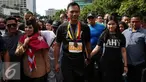 Pasangan Cagub dan Cawagub DKI Jakarta, Agus Harimurti Yudhoyono ditemani Istri Anisa Pohan dan Sylviana Murni menyapa warga Jakarta saat berlangsungnya Car Free Day (CFD) di kawasan Bundaran HI, Minggu (2/10). (Liputan6.com/Johan Tallo)