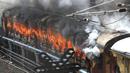 Kobaran Api melahap kereta api yang dibakar pengunjuk rasa di stasiun kereta api Secunderabad di Hyderabad, India, Jumat (17/6/2022). Hampir 500 pengunjuk rasa jauh melebihi jumlah polisi saat mereka mengamuk selama lebih dari satu jam di stasiun kereta api Secundrabad di India selatan. (AP Photo/Mahesh Kumar A)