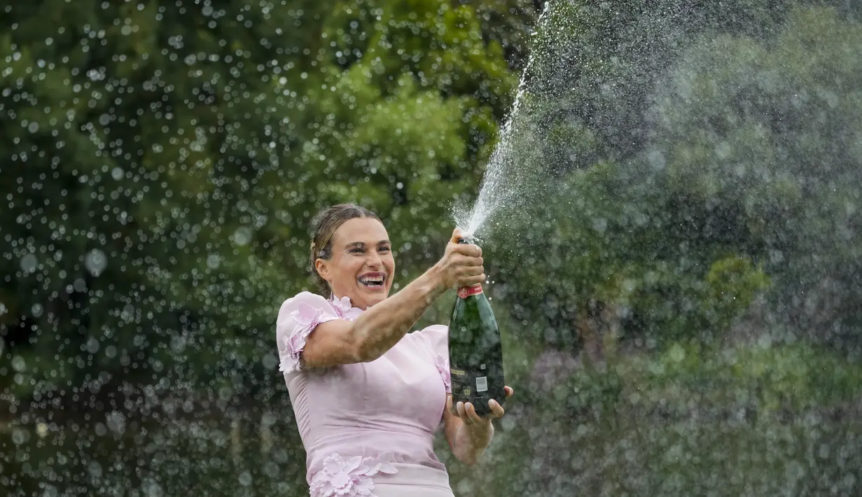 Aryna Sabalenka dari Belarusia menyemprotkan sampanye di Royal Botanical Gardens setelah mengalahkan Elena Rybakina dari Kazakhstan pada final tunggal putri kejuaraan tenis Australia Open 2023 di Melbourne, Minggu (29/1/2023). Kemenangan ke-11 berturut-turut tahun ini juga membawa Sabalenka kembali ke peringkat kedua WTA di belakang Iga Swiatek dari Polandia. (AP Photo/Dita Alangkara)