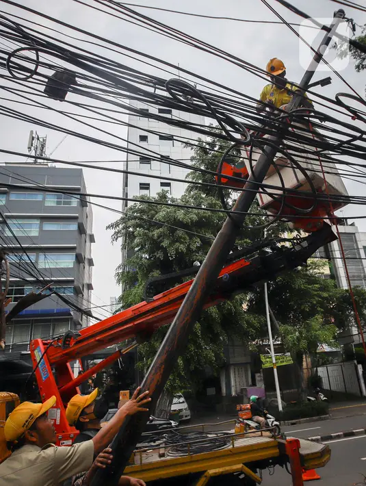 Petugas Satgas Bina Marga Jakarta Pusat melakukan penataan jaringan utilitas di kawasan Wahid Hasyim, Jakarta, Selasa (15/3/2022). Penataan kabel utilitas yang semrawut diharapkan meningkatkan kualitas pedesterian DKI Jakarta sehingga pejalan kaki merasa aman dan nyaman. (Liputan6.com/Faizal Fanani)