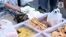 Pedagang menyiapkan makanan untuk berbuka puasa di kawasan Bendungan Hilir, Jakarta, Sabtu (25/4/2020). Meski ditengah pandemi virus Covid-19, masyarakat masih antusias berburu penganan berbuka puasa dengan tetap menerapkan pola jaga jarak dan memakai masker. (Liputan6.com/Helmi Fithriansyah)