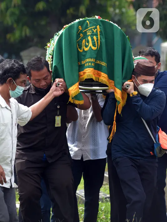 Sejumlah orang mengangkat keranda berisi jenazah mendiang mantan pebuku tangkis Indonesia Markis Kido saat pemakaman di TPU Kebon Nanas, Jakarta, Selasa (15/6/2021). Peraih mendali emas Olimpiade Beijing 2008 tersebut meniggal di Tangerang pada 14 Juni 2021 malam. (merdeka.com/Imam Buhori)