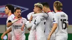 Pemain AC Milan merayakan gol yang dicetak Samuel Castillejo Azuaga ke gawang Lille pada laga lanjutan Liga Europa di Stade Pierre Mauroy, Jumat (27/11/2020) dini hari WIB. AC Milan bermain imbang 1-1 menghadapi Lille. (AFP/Dennis Charlet/pool)
