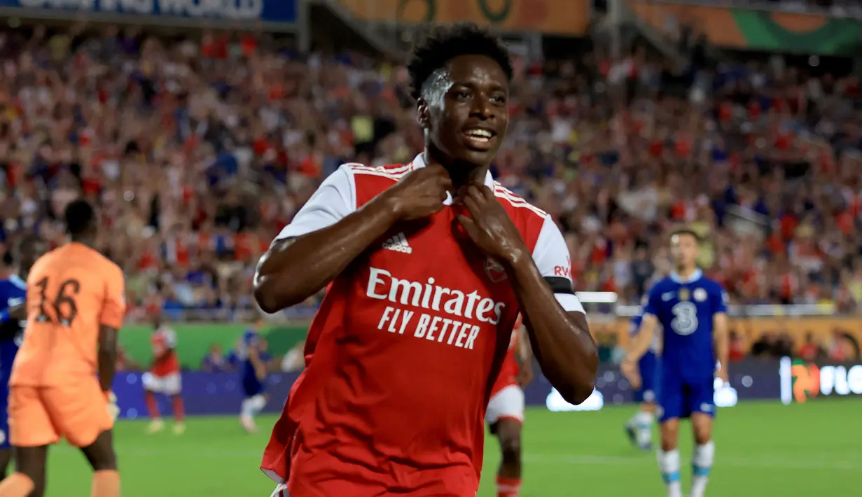 Selebrasi gelandang Arsenal, Albert Sambi Lokonga setelah mencetak gol ke gawang Chelsea dalam laga pramusim 2022/2023 di Camping World Stadium, Florida (23/7/2022). Pemain asal Belgia ini didatangkan Arsenal pada awal musim 2021/2022 dari Anderlecht sebagai alternatif di lini tengah The Gunners. Namun akibat kalah bersaing dengan rekannya yang lebih senior, ia pun akhirnya dipinjamkan sejak awal musim 2022/2023 ke Crystal Palace. (AFP/Getty Images/Sam Greenwood)