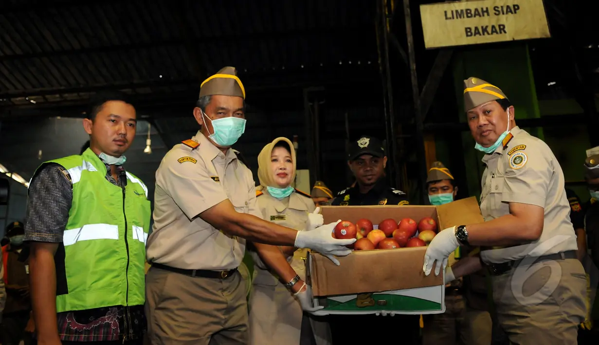 Kepala Badan Karantina Kementerian Pertanian, Banun Harpini (ketiga dari kiri) menunjukkan salah satu jenis apel tidak layak dan tidak aman makan untuk dimusnahkan di Karawang, Jawa Barat, Jumat (6/3/2015). (Liputan6.com/Helmi Fithriansyah)