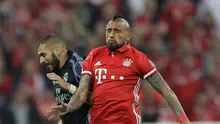 Pemain Bayern Muenchen Arturo Vidal melompat merebut bola dari pemain Real Madrid, Karim Benzema pada leg pertama perempat final Liga Champions di Stadion Allianz Arena, Kamis (13/4). Real Madrid unggul tipis 2-1 atas Muenchen (AP Photo/Matthias Schrader)