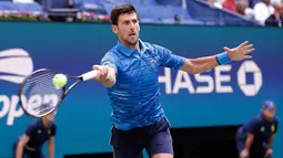Petenis Serbia, Novak Djokovic mengembalikan bola ke arah lawannya Roberto Carballes Baena dari Spanyol pada  babak pertama AS Terbuka 2019 di Billie Jean King National Tennis Center, New York, Senin (26/8/2019). Unggulan pertama itu memetik kemenangan 6-4, 6-1, 6-4. (AP/Frank Franklin II)
