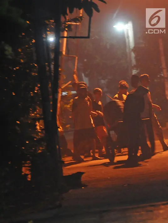 Sejumlah anak menabuh alat musik dari tong sampah berkeliling kampung di kawasan Mekarsari, Depok, Jawa Barat, Rabu (8/5/2019). Kegiatan tersebut merupakan tradisi selama bulan ramadan membangunkan warga untuk sahur. (Liputan6.com/Herman Zakharia)