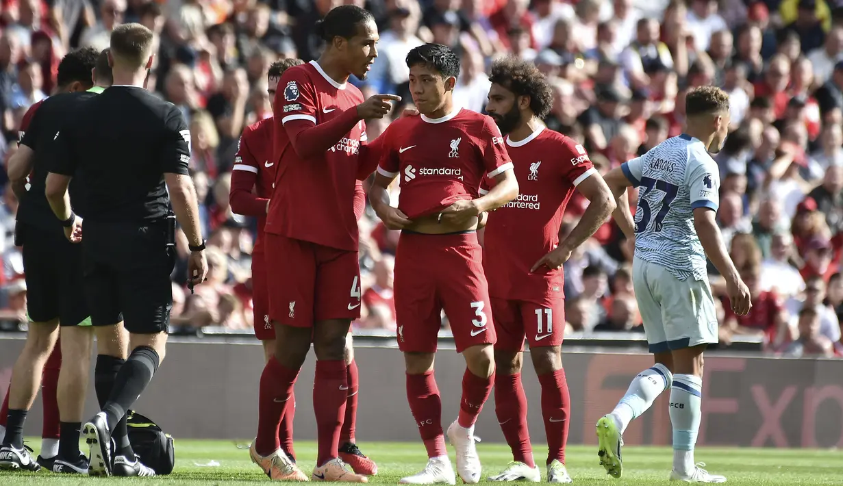 Pemain Liverpool, Wataru Endo (tengah) berbincang dengan rekannya, Virgil van Dijk pada laga pekan kedua Liga Inggris 2023/2024 melawan Bournemouth di Anfield, Liverpool, Sabtu (20/08/2023) malam WIB. (AP Photo/Rui Vieira)