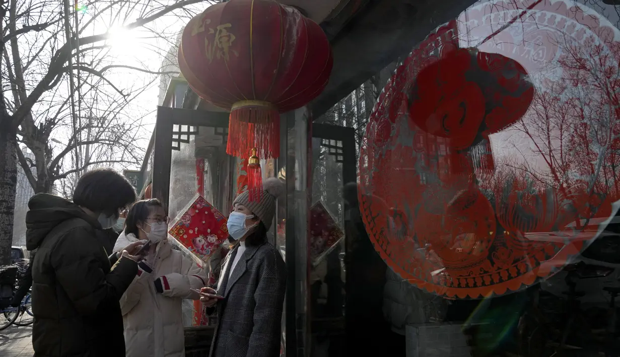 Orang-orang berbaris untuk makan pangsit di sebuah restoran seperti yang biasa dilakukan selama hari titik balik matahari musim dingin di Beijing, China, Selasa (21/12/2021). Pangsit adalah makanan festival selama hari titik balik matahari musim dingin. (AP Photo/Ng Han Guan)