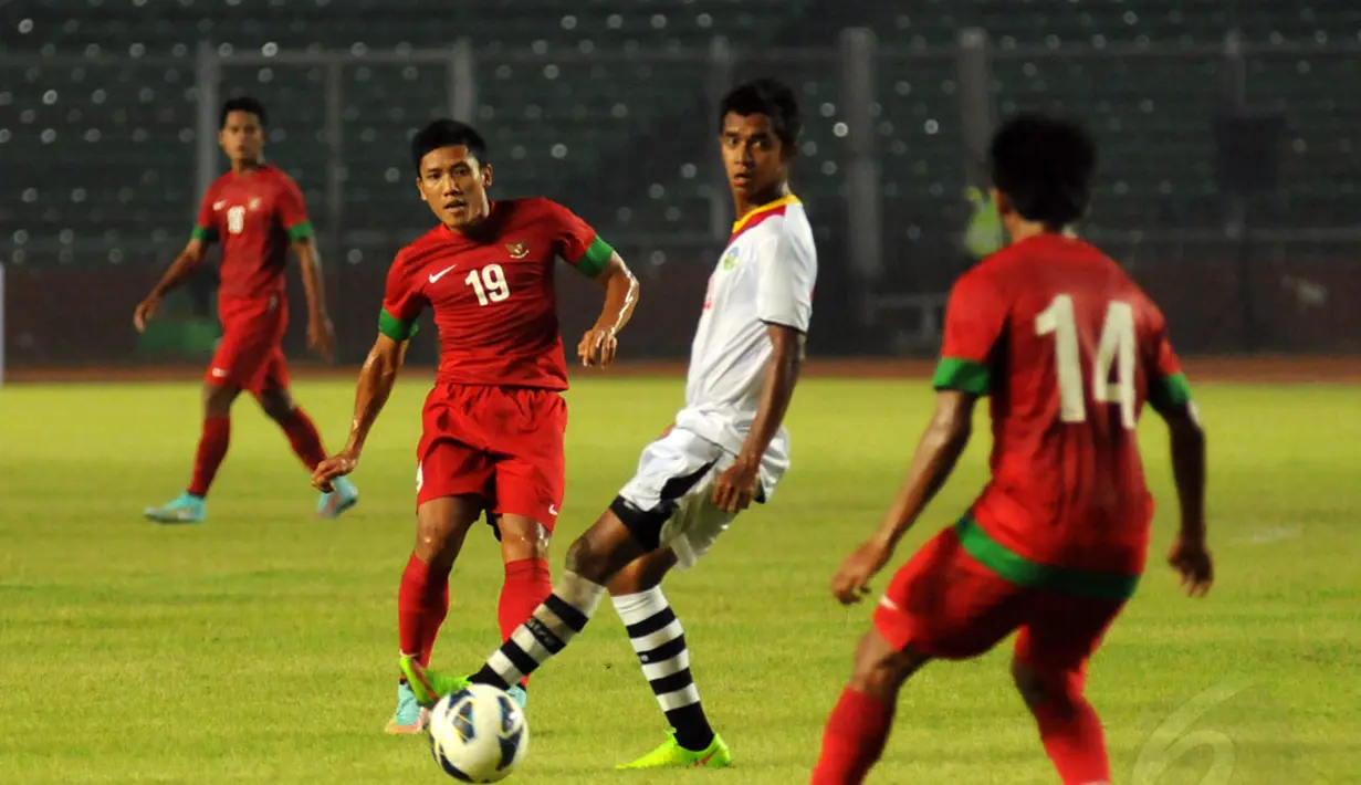 Gelandang Timnas Indonesia, Ahmad Bustomi (kedua dari kiri) berusaha menembus pertahanan Timor Leste dalam laga persahabatan di Stadion GBK Jakarta, Selasa (11/11/2014).Indonesia unggul 4-0 atas Timor Leste. (Liputan6.com/Helmi Fithriansyah)