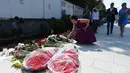 Sejumlah orang saat ingin meletakkan karangan bunga di luar Kedutaan Besar Prancis di Moskow, Rusia, (15/7). Sedikitnya 84 orang tewas dan ratusan lainnya luka akibat hantaman truk tersebut. (AFP PHOTO/Vasily Maximov)