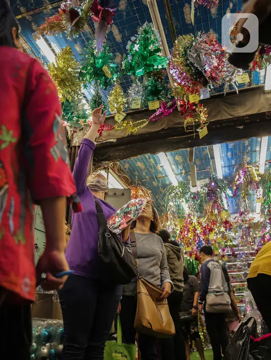 Calon pembeli memilih pernak-pernik Natal yang dijual di Pasar Asemka, Glodok, Jakarta, Kamis (12/12/2019). Umat Kristiani mulai mendatangi pusat perbelanjaan untuk berburu pernak-pernik penghias rumah dan pohon Natal. (Liputan6.com/Faizal Fanani)