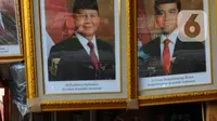 Pedagang bingkai foto bergambar presiden dan wakil presiden terpilih 2024-2029 menunggu pembeli di Pasar Baru Jakarta, Senin (22/4/2024). (merdeka.com/Imam Buhori)