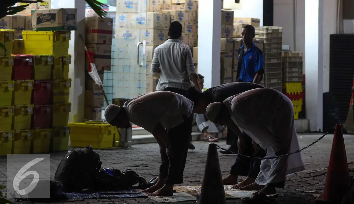 Salat Magrib berjamah dilaksanakan sejumlah peserta Aksi Damai 4 November di depan sebuah mini market, Jakarta, Jumat (4/11). (Liputan6.com/Faizal Fanani)
