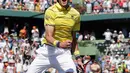Petenis AS, John Isner melompat merayakan kemenangan atas petenis Jerman Zverev di final Miami Terbuka 2018, Minggu (1/4). Kemenangan ini akan membuat Isner menjadi petenis AS dengan peringkat tertinggi, urutan kesembilan. (AP/Lynne Sladky)