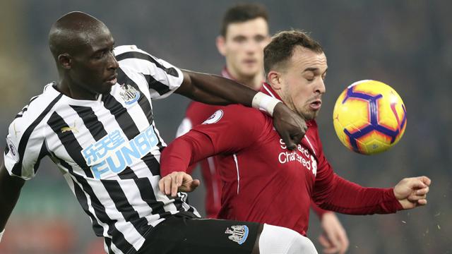 Gelandang Liverpool, Xherdan Shaqiri, berusaha melewati bek Newcastle, Mohamed Diame, pada laga Premier League di Stadion Anfield, Liverpool, Rabu (26/12). Liverpool menang 4-0 atas Newcastle. (AP/Jon Super)