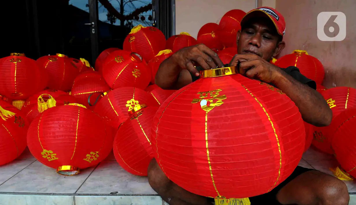 Pekerja menyiapkan lampion untuk dipasang di halaman Klenteng Hok Lay Kiong, Kelurahan Margahayu, Bekasi, Jawa Barat, Jumat (13/1/2023). Pemasangan ratusan lampion dari pintu masuk hingga bagian dalam klenteng itu untuk menyambut Tahun Baru Imlek 2574 yang akan jatuh pada 22 Januari 2023 mendatang. (merdeka.com/Imam Buhori)