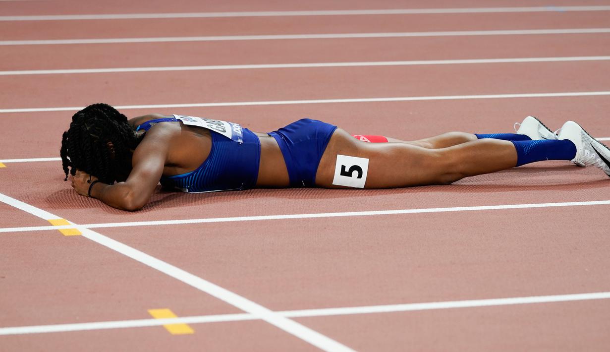 Sprinter Amerika Serikat, English Gardner tengkurap di trek balap saat mengalami cedera dalam semifinal 100 meter putri Kejuaraan Atletik Dunia di Doha, Qatar, Minggu (29/9/2019). Peraih medali emas olimpiade tersebut mengalami cedera hamstring. (AP Photo/David J. Phillip)
