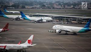 Pesawat maskapai Garuda Indonesia terparkir di areal Bandara Soekarno Hatta, Tangerang, Banten, Kamis (16/5/2019). Pemerintah akhirnya menurunkan tarif batas atas (TBA) tiket pesawat atau angkutan udara sebesar 12-16 persen yang berlaku mulai Kamis hari ini. (Liputan6.com/Faizal Fanani)