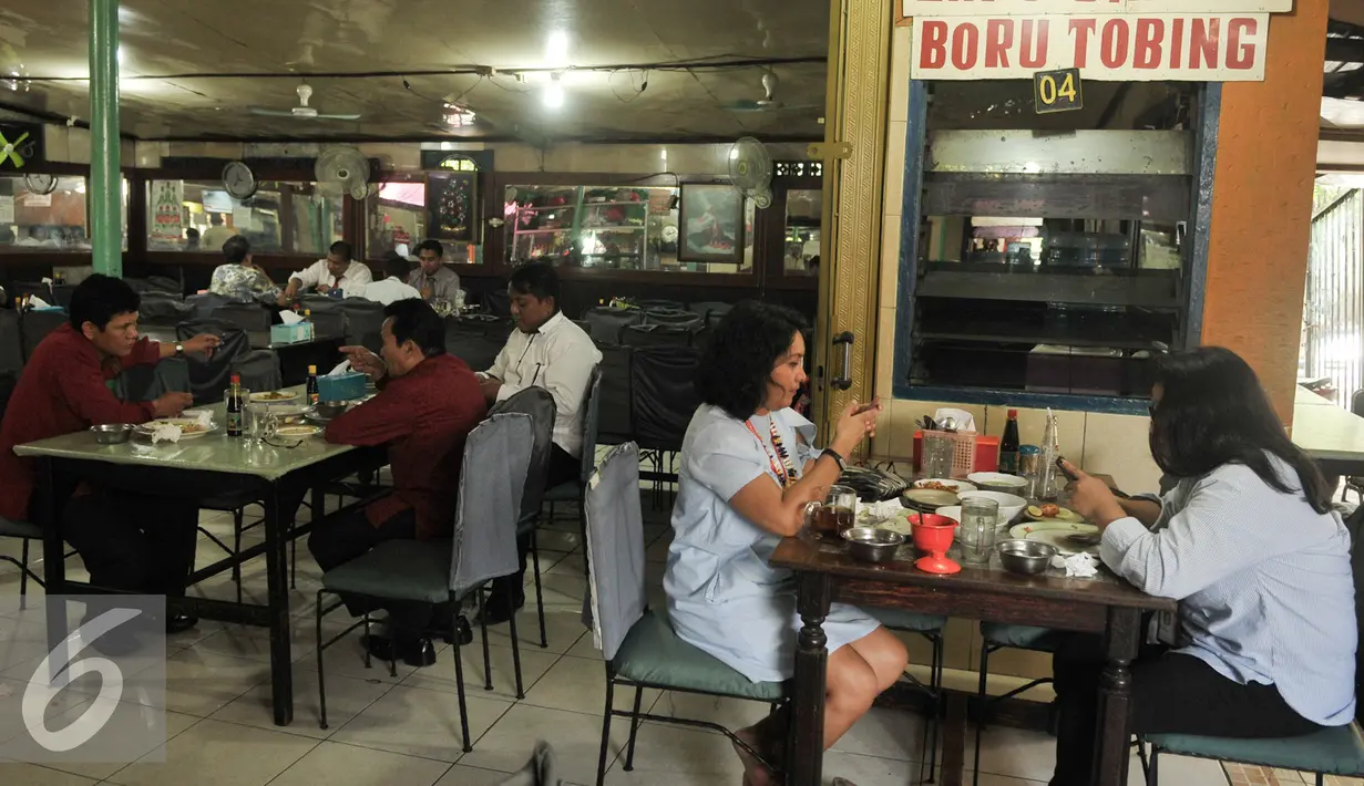 Pengunjung menikmati makan siang makanan di lapo kawasan kuliner khas daerah, Senayan, Jakarta, Rabu (18/1). Tempat kuliner tersebut sudah berdiri hampir 25 tahun. (Liputan6.com/Yoppy Renato)