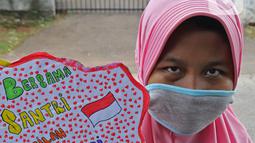 Seorang anak pengajian melakukan pawai di Jalan Raya Tapos, Depok, Jawa Barat, Kamis (22/10/2020). Pengajian Kampung Tapos menggelar pawai menyambut Hari Santri Nasional 2020 yang diperingati setiap tanggal 22 Oktober. (Liputan6.com/Herman Zakharia)