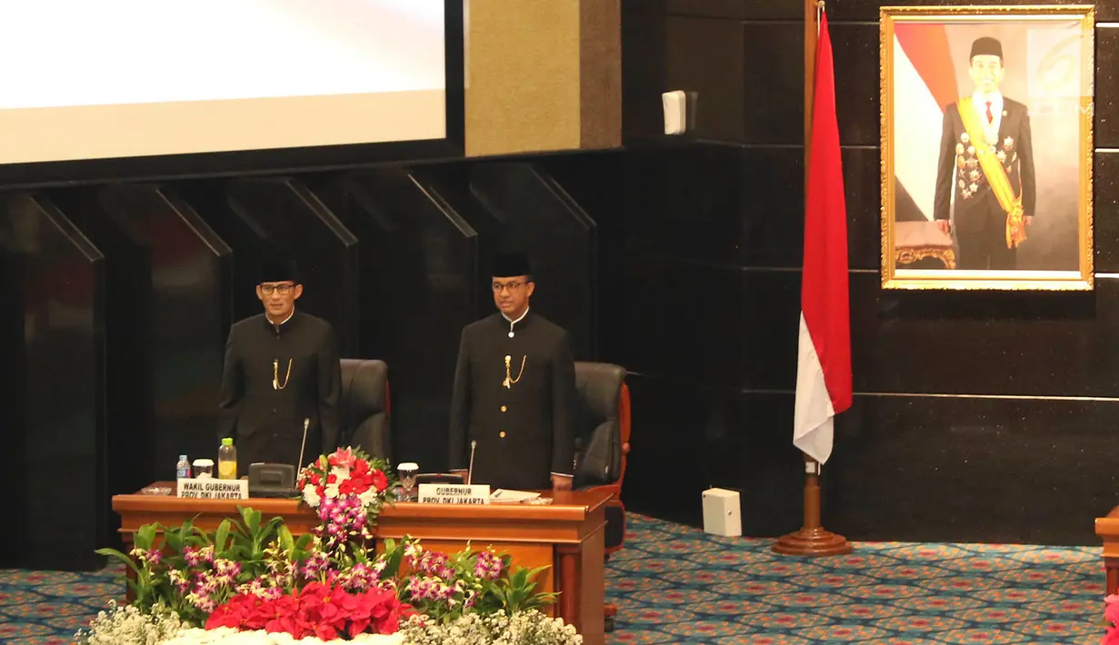 Gubernur dan Wakil Gubernur DKI Jakarta Anies Baswedan (kanan) dan Sandiaga Uno (kiri) saat rapat istimewa bersama DPRD Provinsi DKI Jakarta, Jumat (22/6). Pemprov DKI mengangkat tema 'Adil, Maju, Bahagia' pada HUT ke-491. (Liputan6.com/Immanuel Antonius)