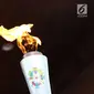 Api obor Asian Games 2018 dalam Torch Relay Asian Games 2018 di kawasan TMII, Jakarta Timur, Rabu (15/8). Pada Jumat (17/8), kirab obor berlanjut di wilayah Kab Administrasi Kepulauan Seribu, lalu ke Monas dan Istana. (Liputan6.com/Immanuel Antonius)