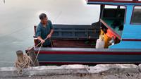 Perahu-perahu nelayan ditambatkan di pantai yang berfungsi sebagai dermaga nelayan. Mereka tak berani melaut karena ombak dan gelombang tinggi. (foto: Liputan6.com/ajang nurdin)