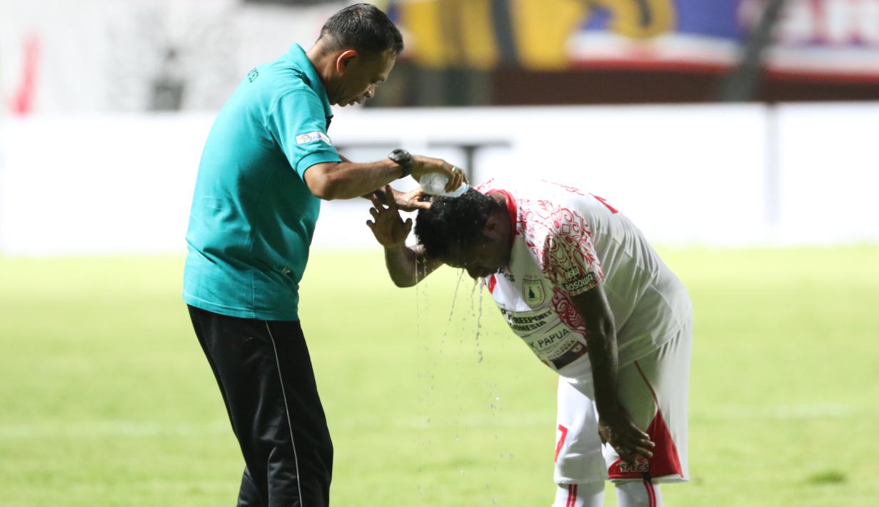 Pemain Persipura Jayapura, Ferinando Pahabol mendapat perawatan dari Official Tim pada laga grup E Piala Jenderal Sudirman di Stadion Maguwoharjo, Sleman, Minggu (13/12/2015) (Bola.com/Nicklas Hanoatubun) 