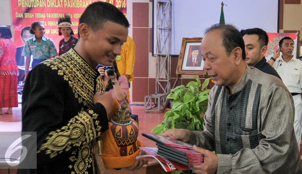 Pemimpin Redaksi SCTV, Indosiar dan Liputan6.com, Mohamad Teguh memberikan video dukumentasi kepada anggota Paskibraka 2016 saat penutupan diklat nasional Paskibraka 2016, Cibubur, Jakarta, Rabu (24/8). (Liputan6.com/Yoppy Renato)