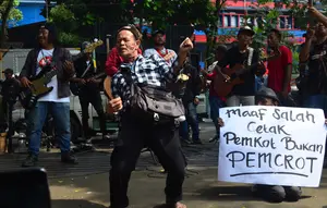 Kelompok Penyanyi Jalanan (KPJ) Kota Bandung menggelar aksi unjuk rasa dengan cara menggelar pertunjukan musik bertajuk Konser Kemiskinan dan Kelaparan di depan kantor DPRD Kota Bandung, Jalan Sukabumi No. 30, Kota Bandung, Senin (20/5/2024). (Dikdik Ripaldi/Liputan6.com)