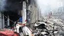Petugas dibantu warga berusaha menjinakkan api yang melahap permukiman di Jalan Kebon Jeruk 13, Taman Sari, Jakarta Barat, Minggu (6/10/2019). Kebakaran diduga akibat anak bermain korek api. (merdeka.com/Iqbal Nugroho)