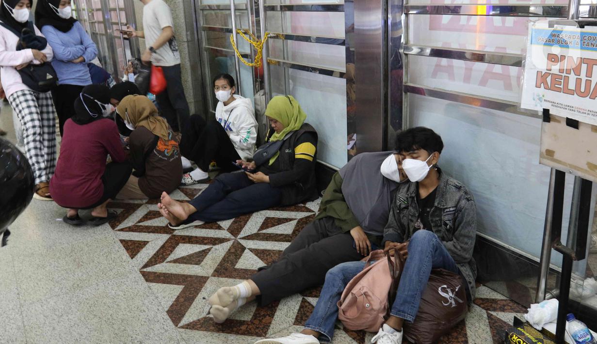 <p>Sejumlah pengunjung beristirahat disela mengunjungi Pasar Tanah Abang, Jakarta, Sabtu (23/4/2022). Menjelang Lebaran, Pasar Tanah Abang dipadati pengunjung yang memburu busana atau pakaian muslim untuk menyambut Hari Raya Idul Fitri 1443 Hijriah. (Liputan6.com/Herman Zakharia)</p>