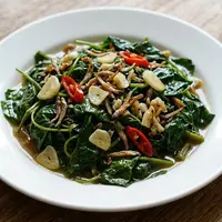 Resep Tumis Daun Ubi Jalar dengan Teri dan Bawang Putih yang Empuk dan Tidak Pahit. (AI Generated)