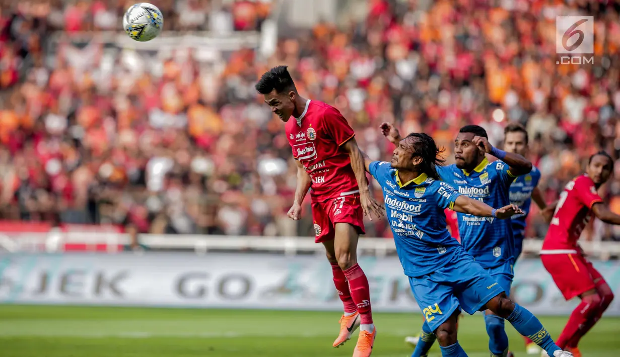 Pemain Persija Jakarta, Yogi Rahadian menyundul bola saat bertanding melawan Persib Bandung pada Shopee Liga 1 di Stadion Utama GBK, Senayan, Jakarta, Rabu (10/7/2019). Dalam pertandingan babak pertama Persija vs Persib masih imbang 0-0. (Liputan6.com/Faizal Fanani)
