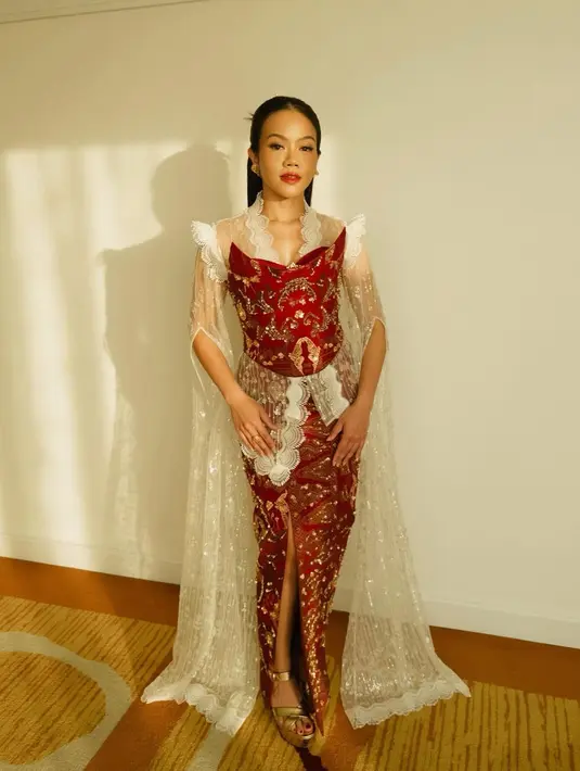 Aksen lace putih di bagian bahu dan dada menambahkan kesan feminin sekaligus dramatis.  [@yurayunita].