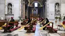 Sejumlah petugas mengikuti Misa Minggu Palma di St. Peter's Basilica, Vatikan, Minggu (5/4/2020). Para petugas tetap menjaga jarak untuk menghindari penyebaran virus corona COVID-19. (AP Photo/pool/Alberto Pizzoli)