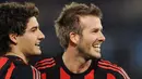 AC Milan's English midfielder David Beckham (R) and teammate Brazilian forward Pato celebrate the goal by midfielder Massimo Ambrosini against Lazio / ALBERTO PIZZOLI