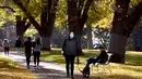 Orang-orang berjalan di taman kota ketika penguncian coronavirus di Melbourne, Australia (3/6/2021). Pihak berwenang mengumumkan Lockdown di Melbourne diperpanjang tujuh hari lagi ketika negara itu berusaha untuk membasmi sekelompok kasus Covid-19 di Melbourne. (AFP Photo/William West)